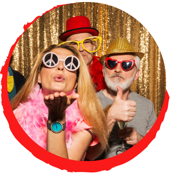 group of partygoers posing in photo booth with props